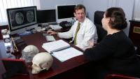 doctor with patient showing scans